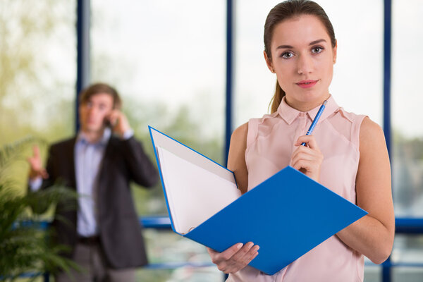 Office worker holding blue folder