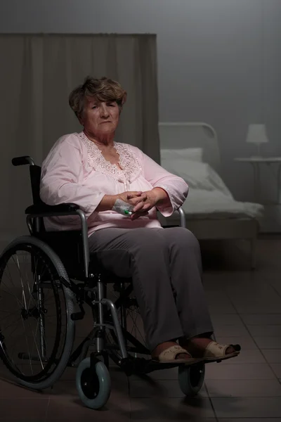 Sad woman sitting on wheelchair — Stock Photo, Image