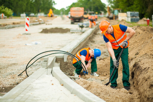 Construction workers renovating road