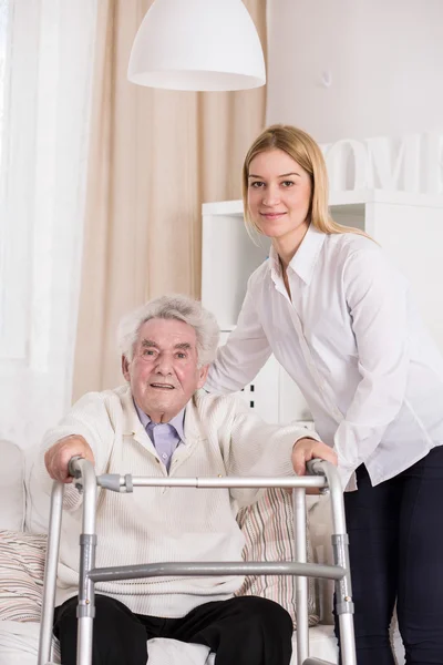 Disabled man using walking frame — Stock Photo, Image