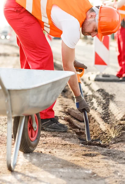 Street workers repairing sidewalk