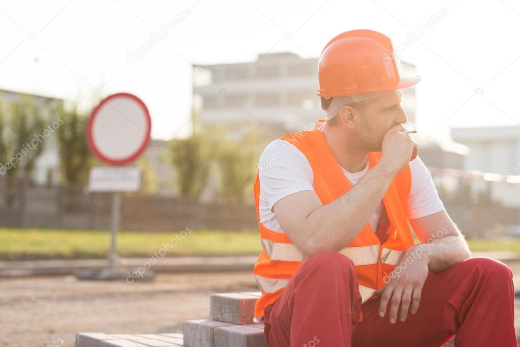 Smoking cigarette on construction site
