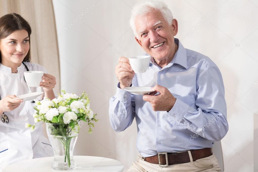 Nurse and retiree drinking coffee