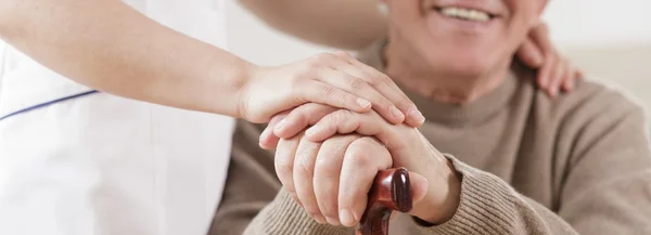 Senior man and caring nurse — Stock Photo, Image