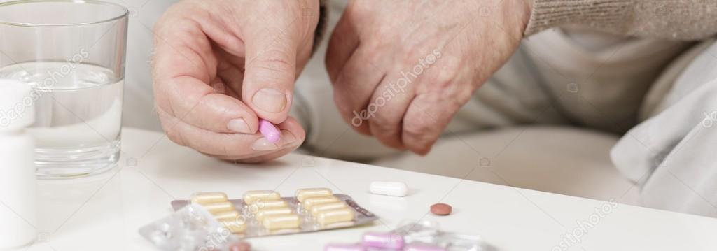 Ill person taking medicine