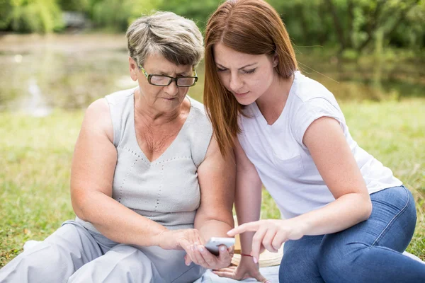 Woman teaching grandma — Stock Photo, Image