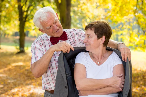 Senior man covering his wife — Stock Photo, Image