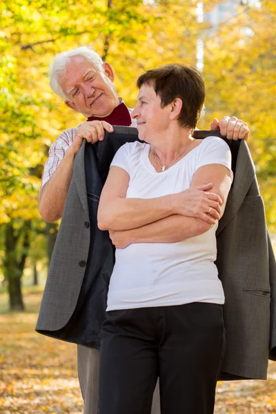 Elderly man caring about his wife — Stock Photo, Image