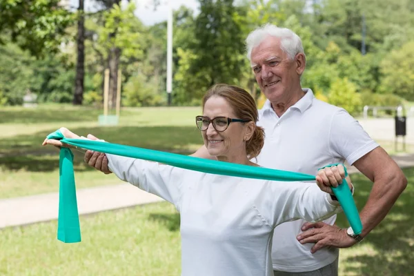 Senior exercising with pilates band — Stock Photo, Image