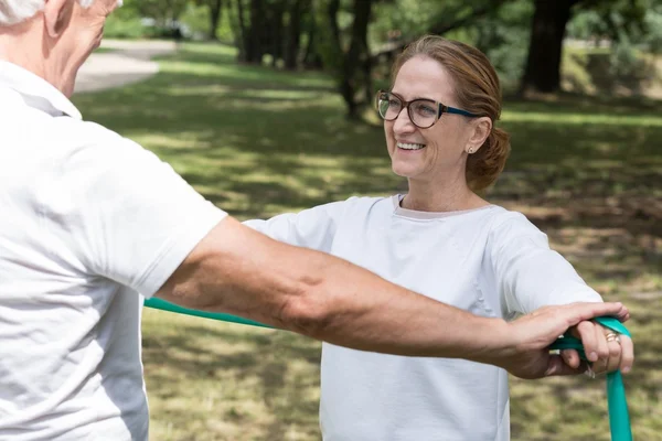 Elderly pair workout with band — Stock Photo, Image