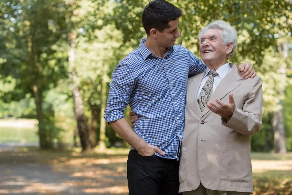 Rich elderly male and carer — Stock Photo, Image