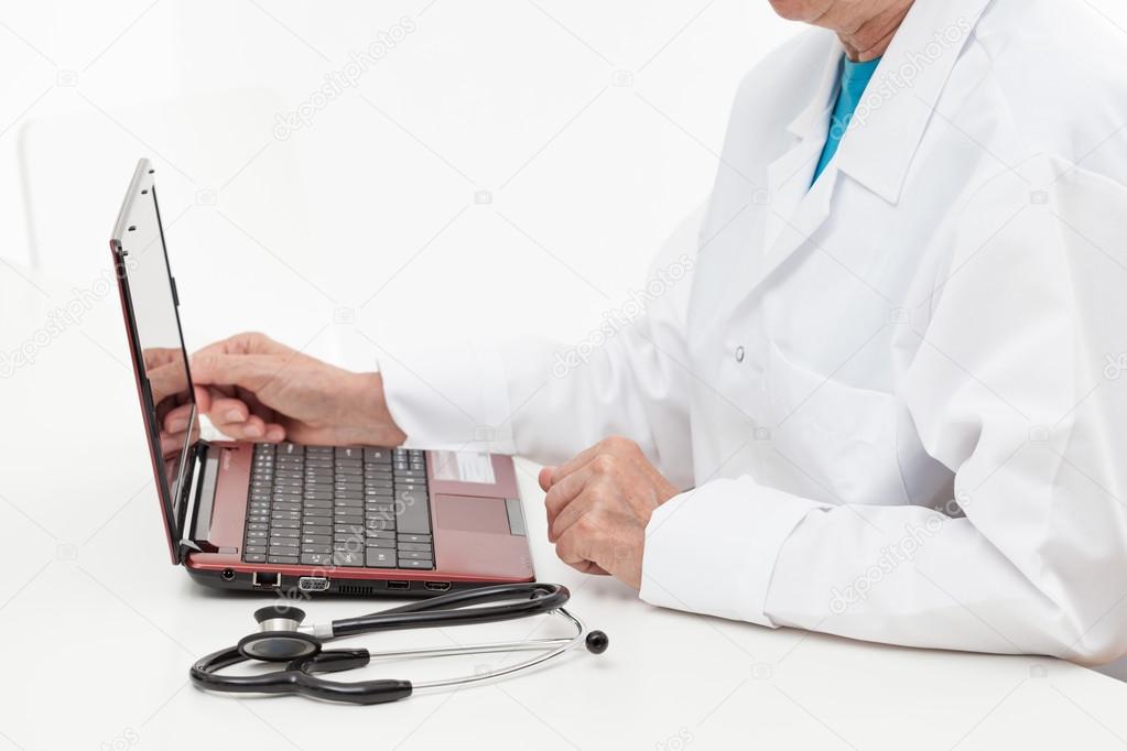 Doctor with laptop and stethoscope