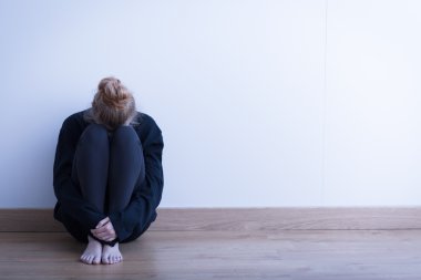 Woman sitting curled up