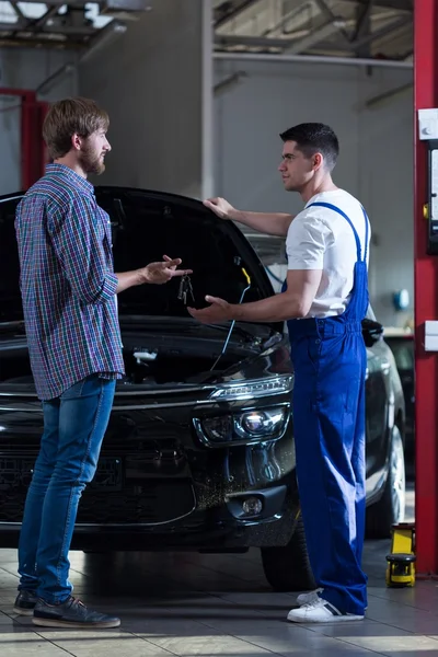 Man and mechanic at workshop — Stock Photo, Image