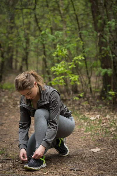 Active girl checking her shoes — Stock Photo, Image