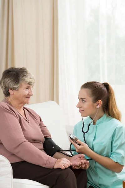 Nurse measuring blood pressure — Stock Photo, Image