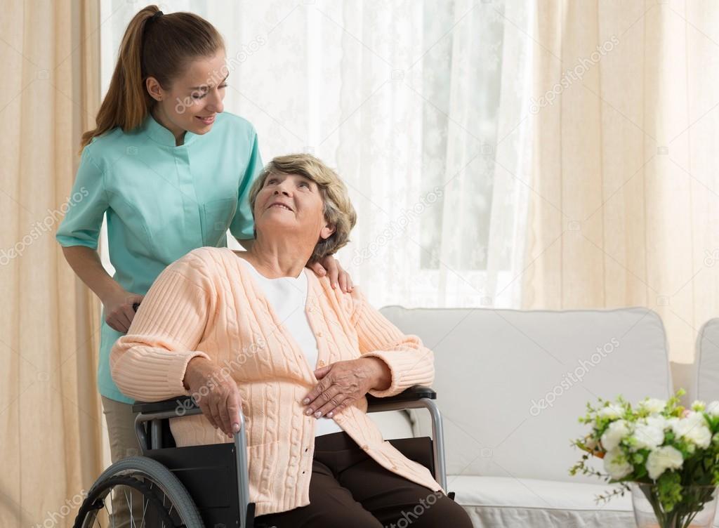 Nurse discussing with elder patient