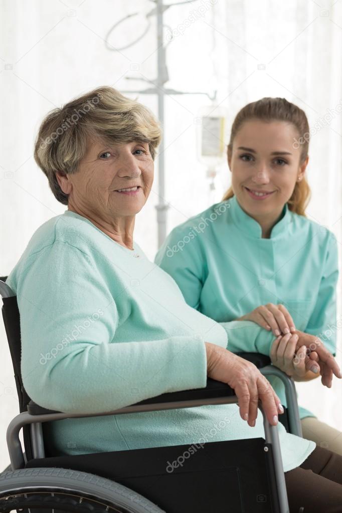 Smiling disabled woman and nurse