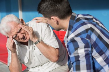 Senior man suffering from dizziness clipart