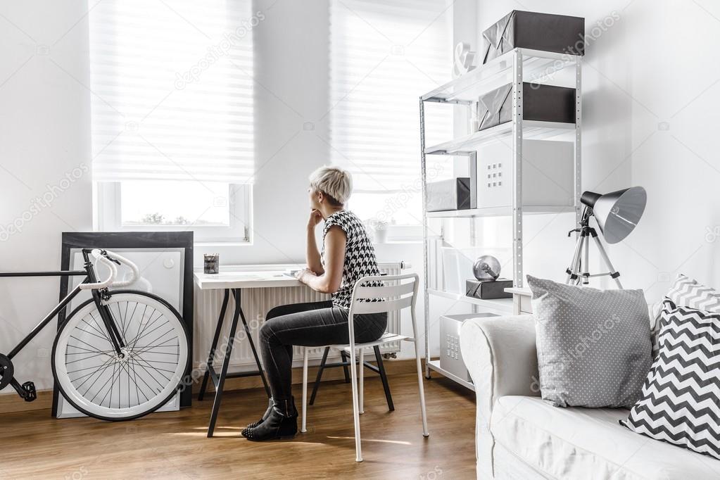 Thinking woman in modern studio