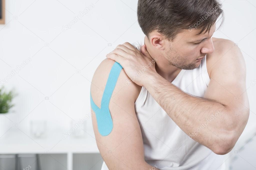 Athletic man during kinesiotherapy