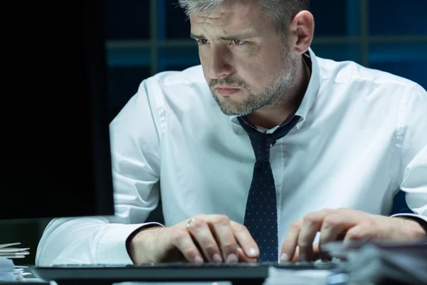 Tired businessman working at night — Stock Photo, Image