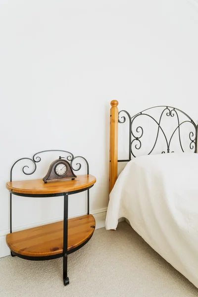 Wooden bed and nightstand — Stock Photo, Image