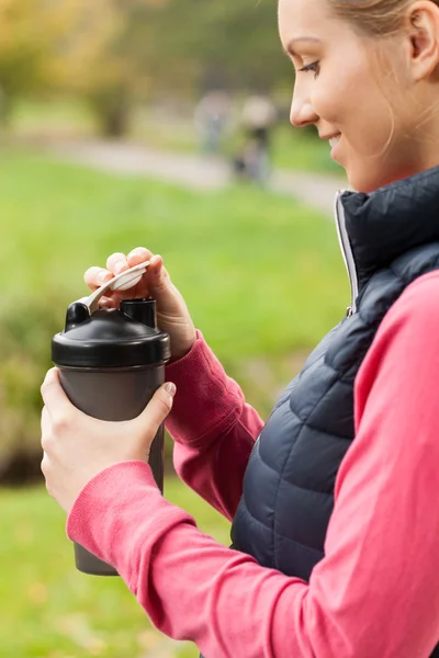 Donna che beve acqua durante il jogging — Foto Stock