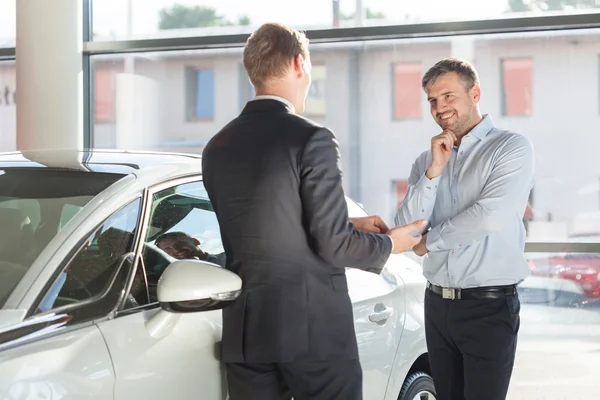 Happy customer of car showroom — Stock Photo, Image