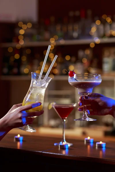 Female hands raising the glass — Stock Photo, Image