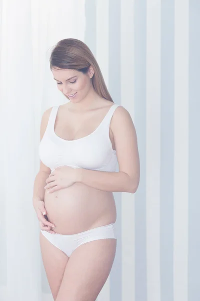 Pregnant woman touching her belly — Stock Photo, Image