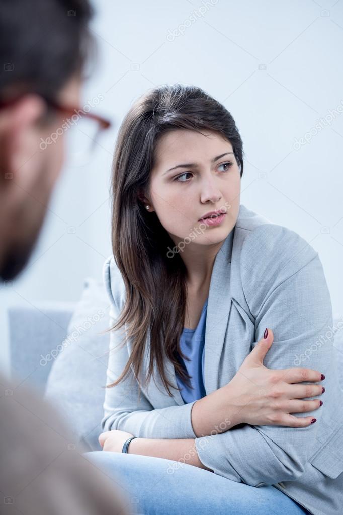 Scared woman receiving psychotherapy