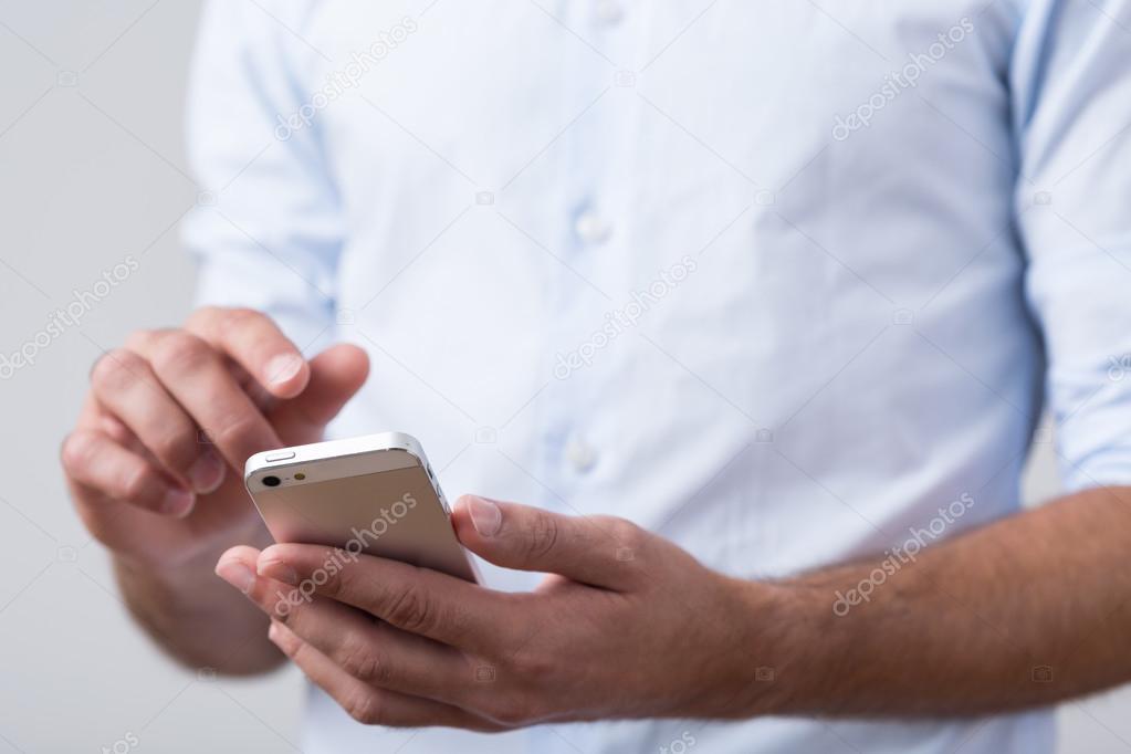 Male hands holding mobile phone