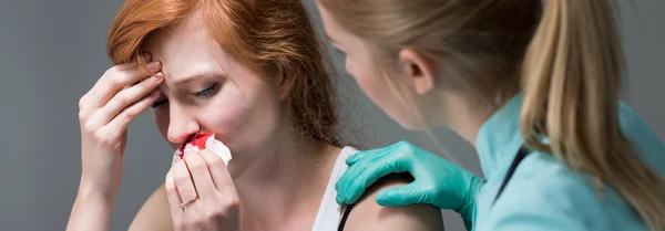 Young woman with nosebleed — Stock Photo, Image