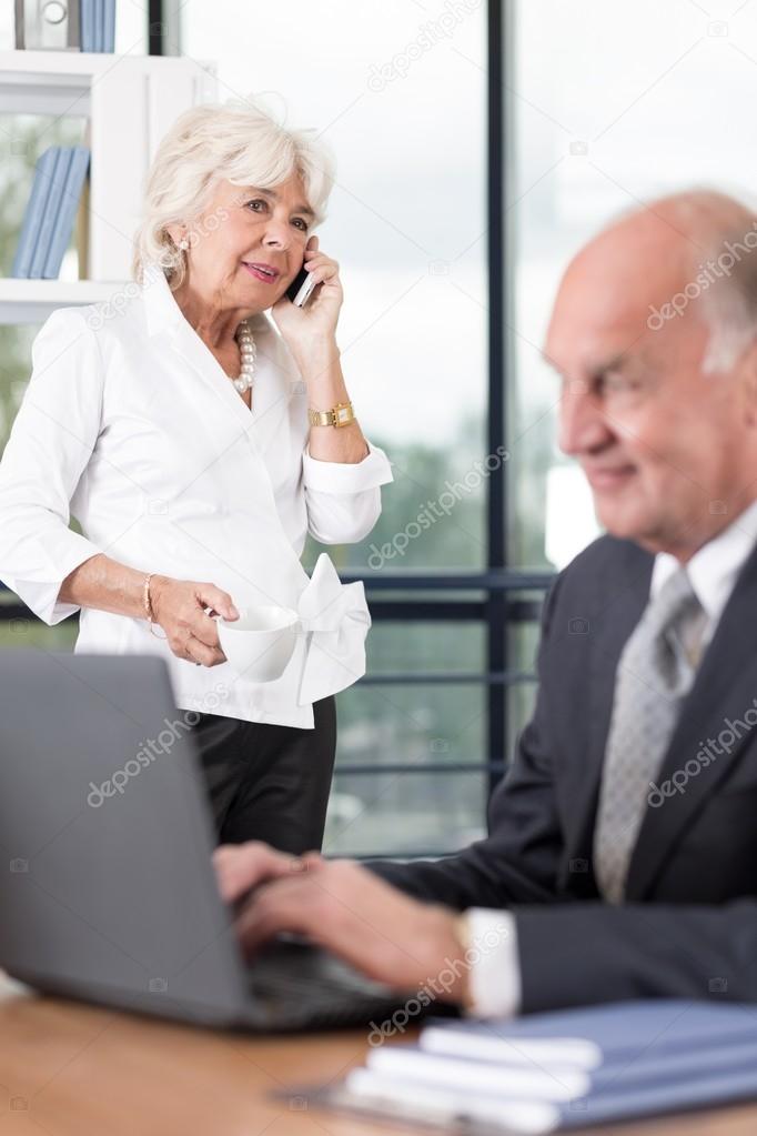 Senior business couple working