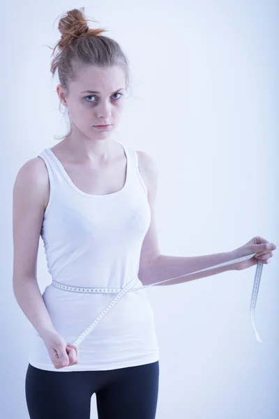 Anorexic girl with measuring tape — Stock Photo, Image