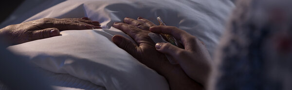 Person assisting dying hospice patient 