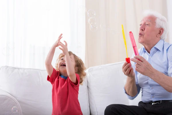 Grandfather letting bubbles — Stock Photo, Image
