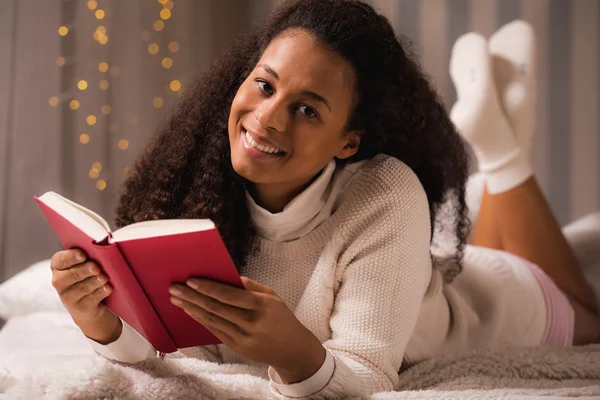 Happy lady relaxing with book Stock Image