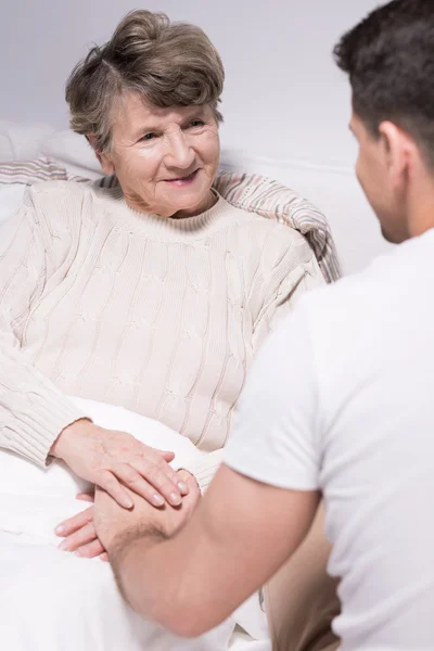 Grandson visiting grandmother at hospital — Stock Photo, Image