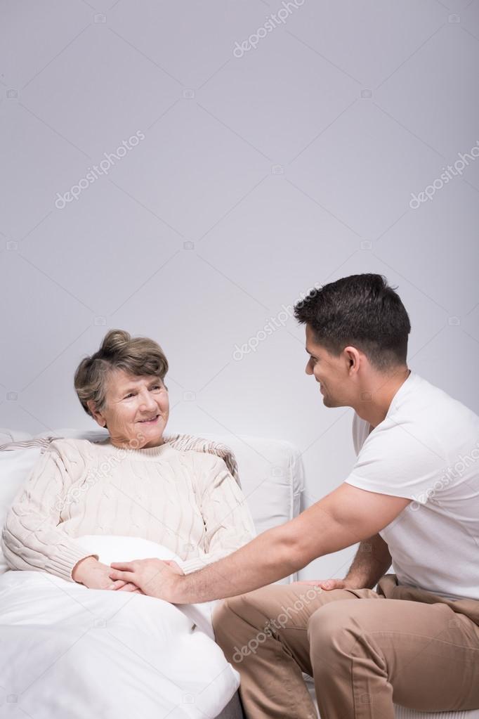 Man helping his ill grandmother