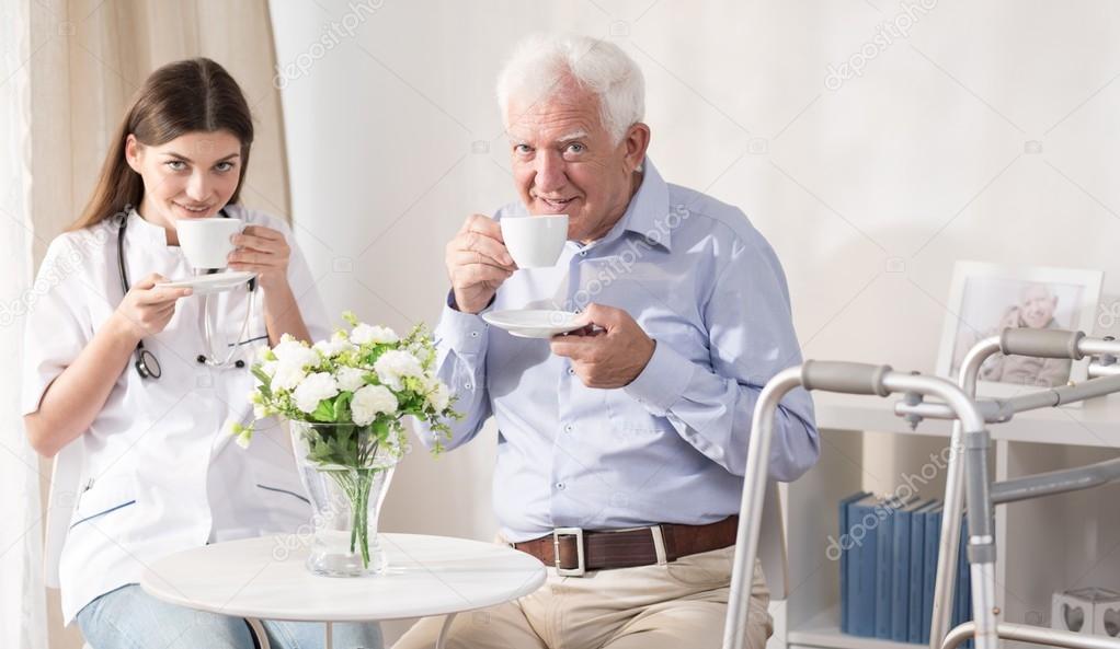 Nurse and patient drinking tea