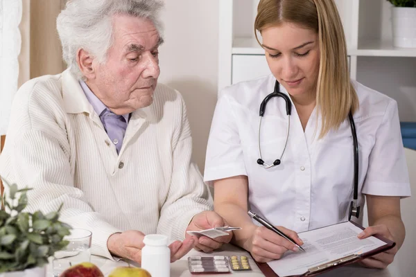 Doctor writing medical prescription — Stock Photo, Image