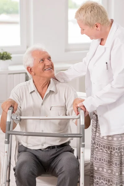 Professional carer helping her patient — Stock Photo, Image