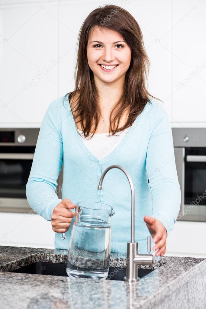 Woman filling up jug