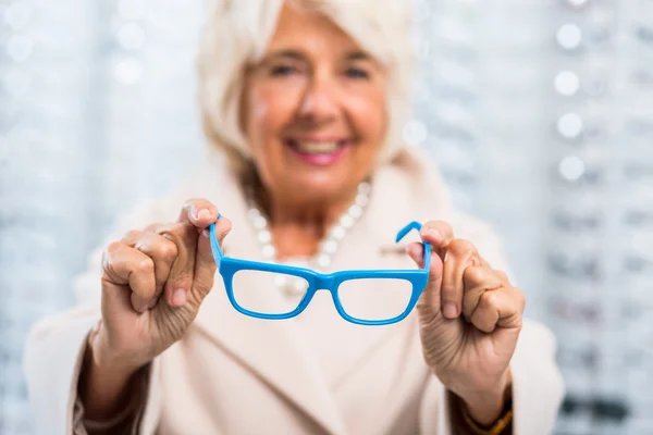 Woman holding blue frames — Stock Photo, Image