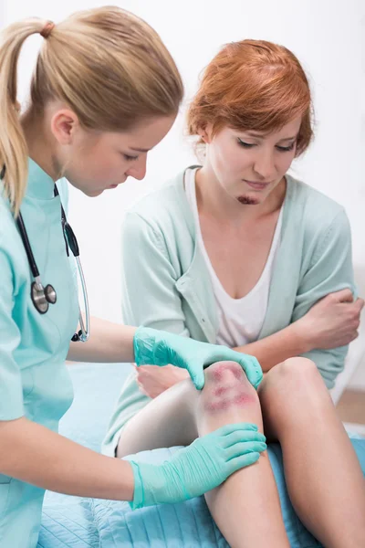 Bruised woman in doctor's office — Stock Photo, Image