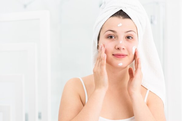 Woman using moisturizing cream