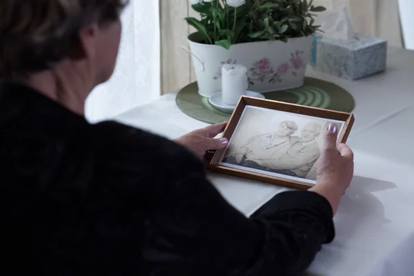 Lonely aged female holding photo — Stock Photo, Image