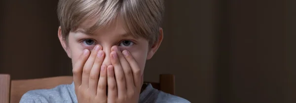 Rädd pojke som täcker hans ansikte — Stockfoto